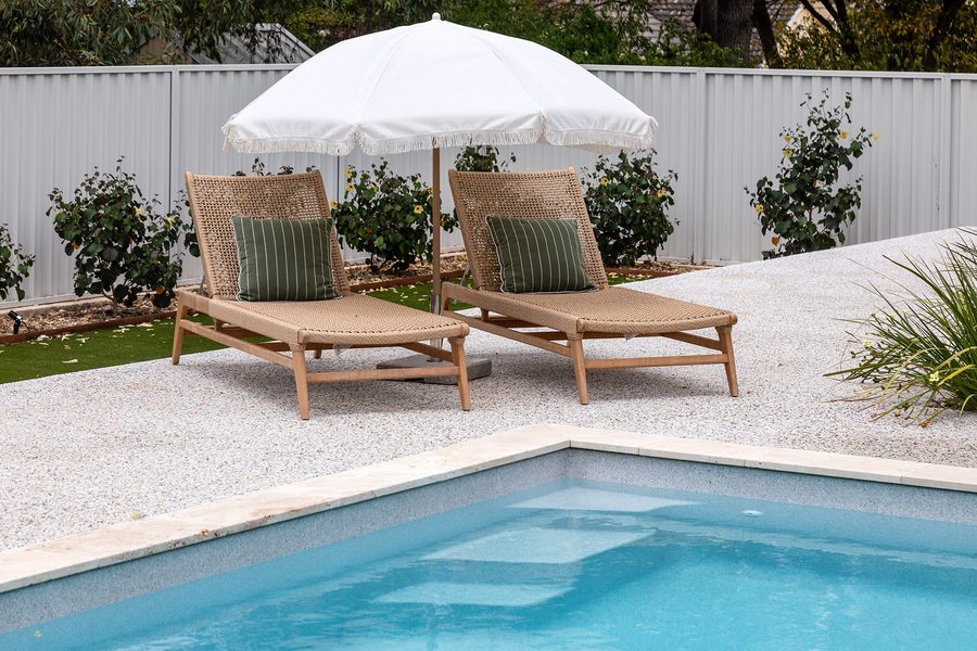 Finished fibreglass pool with sun loungers and a garden border, from the Wetlife Pool Co gallery